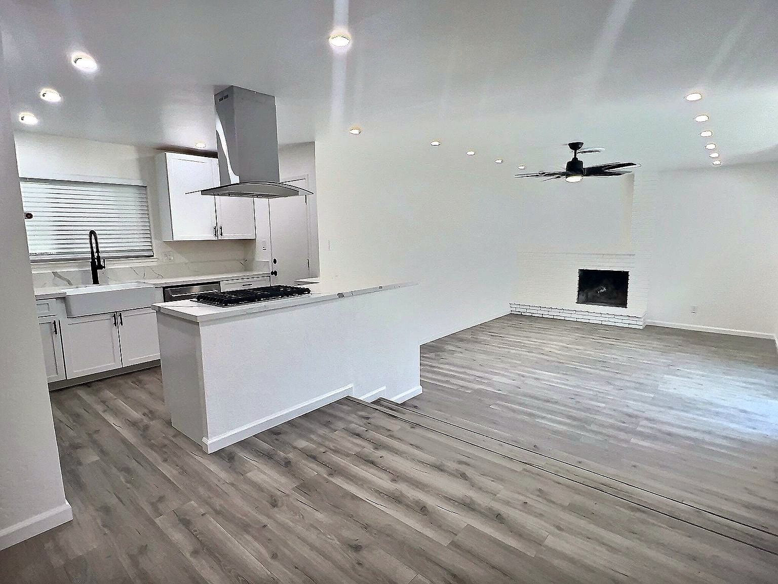 Remodeled open living area with fireplace